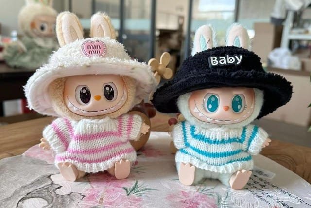 labubu clothes Two dressed stuffed animals wearing hats and clothes, showcasing Labubu Clothes in a playful arrangement.